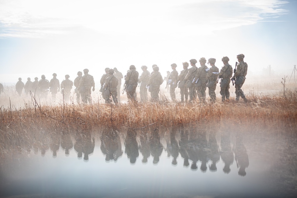 Service members walking onto a land-navigation course at Fort Carson.